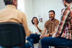 Group of happy individuals in therapy session