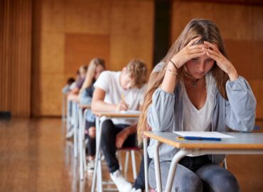 A high school girl stressed over taking a test.